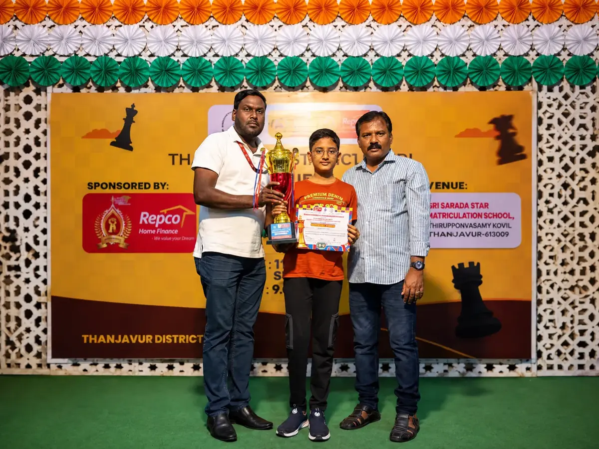 Prize giving at a state-level chess tournament in Thanjavur, a player receiving a trophy and certificate